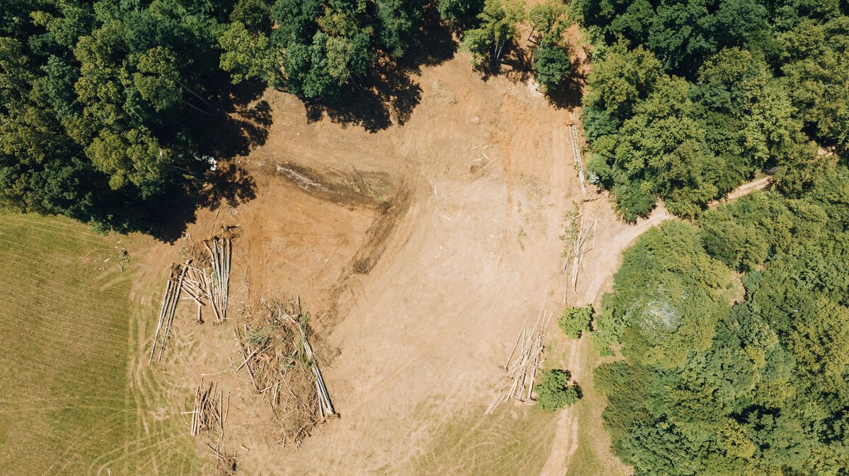 Drone view of cleared site with equipment staged